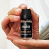 Aloha Shot fragrance oil The Candle kitchen, A small bottle of Aloha Shot fragrance oil held in a person's hand.