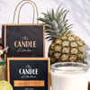 Aloha Shot Soy Candle the candle kitchen Candle with 'The Candle Kitchen' branding, pineapple, and gift bag on a white background