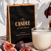 Black Fig Soy Candle from The Candle Kitchen with figs on a textured surface