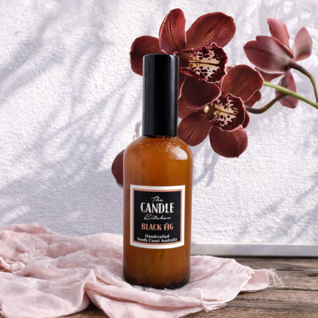 Black Fig room spray Candle Kitchen, Bottle of 'The Candle Kitchen Black Fig' with a pink orchid in the background