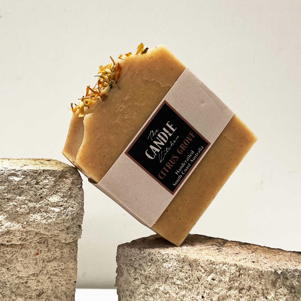 Bar of soap with a visible brand label on a stone surface