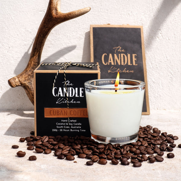 Candle from The Candle Kitchen with packaging and coffee beans on a light background