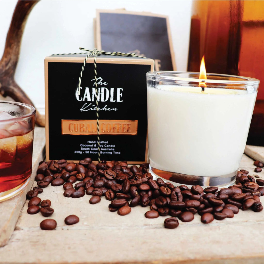 Candle in a glass jar with coffee beans and a branded candle box in the background. Coffee Creme Candle