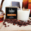 Candle in a glass jar with coffee beans and a branded candle box in the background. Coffee Creme Candle