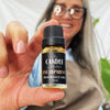 Escarpment fragrance oil The Candle kitchen, A person holding a small bottle labeled 'Escarpment Fragrance Oil' from The Candle Kitchen.