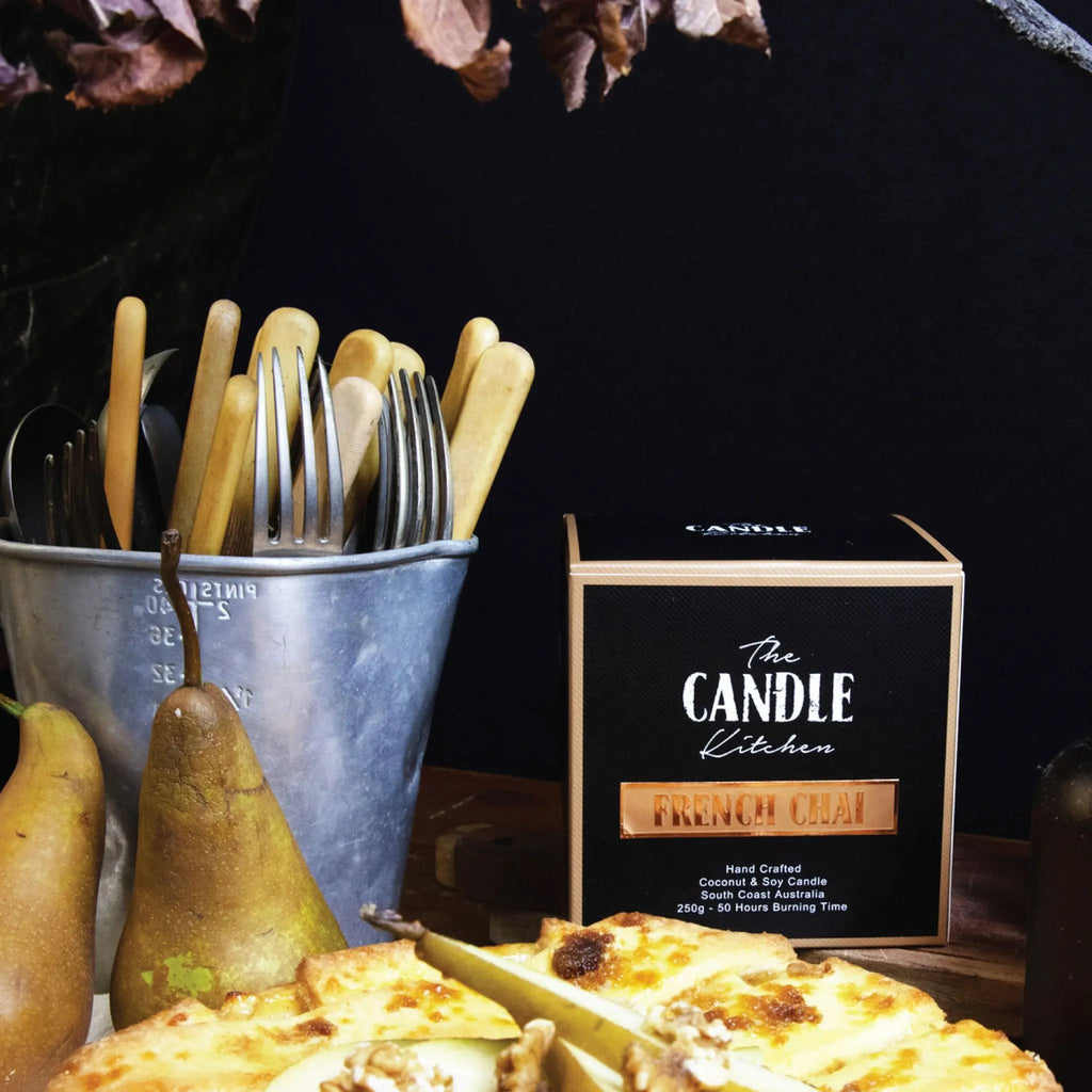 The Candle Kitchen box, pears, and pie on a dark moody background.