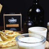 The Candle Kitchen box, pears, and pie on a dark moody background.