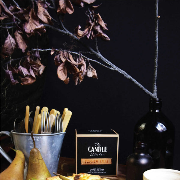 A pear pie and amber bottle in the background, featuring The Candle Kitchen Box.