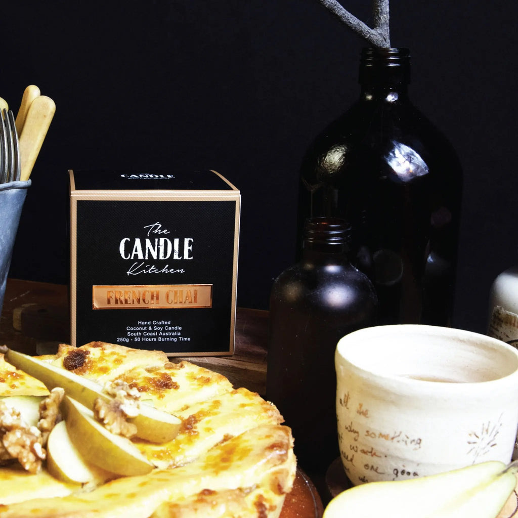 A pear pie and amber bottle in the background, featuring The Candle Kitchen Box.