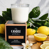 Lemoncello soy candle the candle kitchen on a cutting board full of juicy lemons and branches.Candle with 'The Candle Kitchen' branding surrounded by lemons and greenery