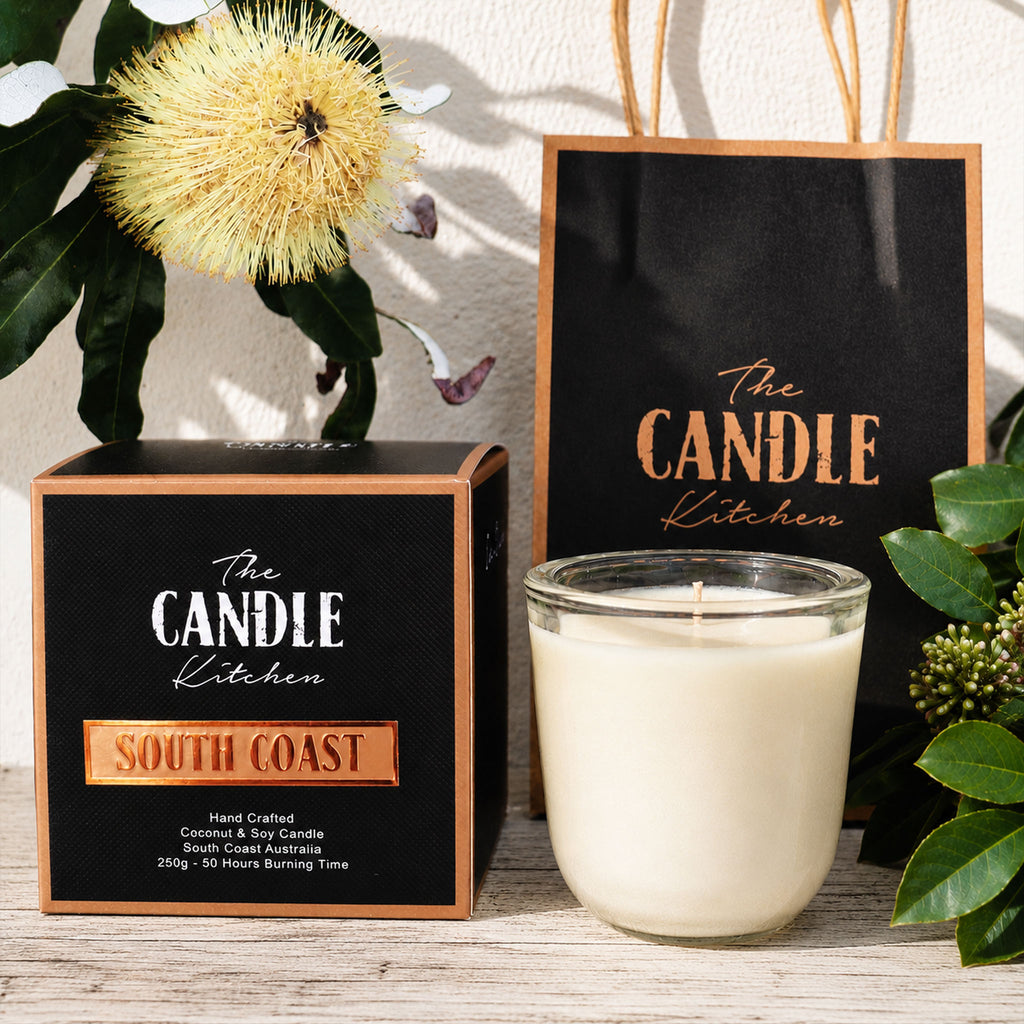 South Coast Soy Candle The Candle kitchen, with packaging and decorative elements on a wooden surface.