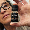 South Coast fragrance oil The Candle kitchen, Petra Delaney holding a small glass jar labeled 'The Candle Kitchen South Coast Fragrance Oil' with a capacity of 10mls.