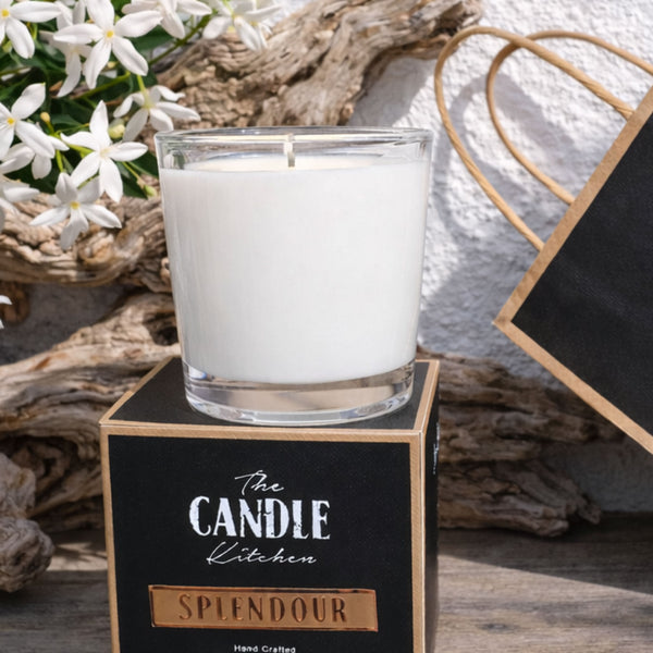 Splendour Soy Candle The Candle kitchen, Candle in a glass holder with white flowers and driftwood on a textured surface