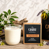 Splendour soy candle Candle with packaging labeled 'The Candle Kitchen Splendour' on a wooden surface with flowers and plants.