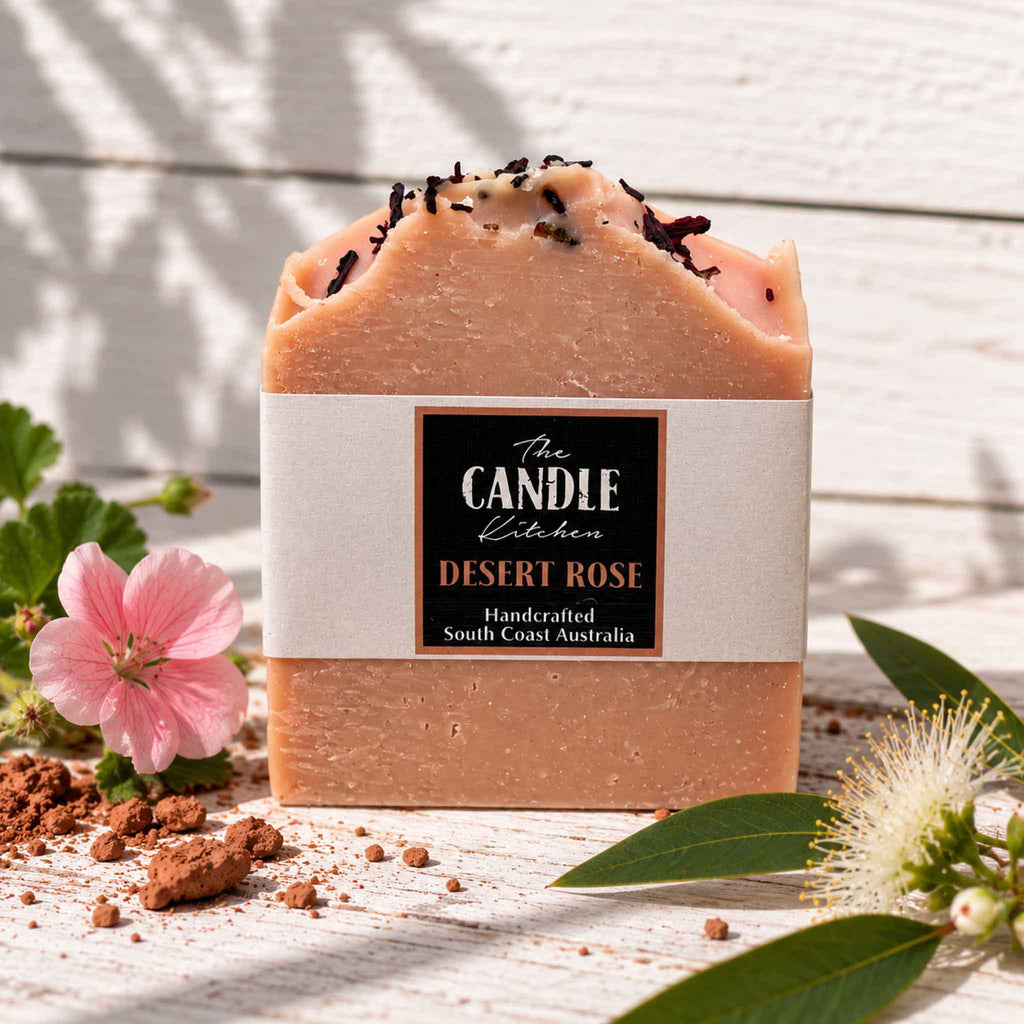 Desert Rose handmade soap, the candle kitchen surrounded with geranium and lemon myrtle flowers sitting on Australian red clay
