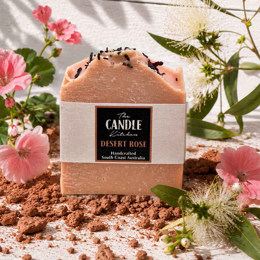 Desert Rose handmade soap, the candle kitchen surrounded with geranium and lemon myrtle flowers sitting on Australian red clay