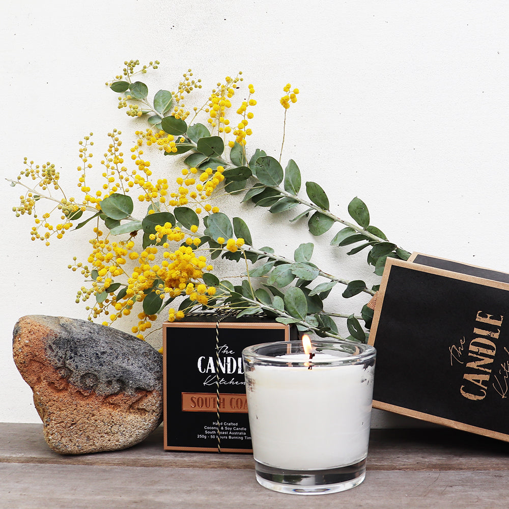 South Coast Candle shot with wattle and sandstone brickSouth Coast of Australia.